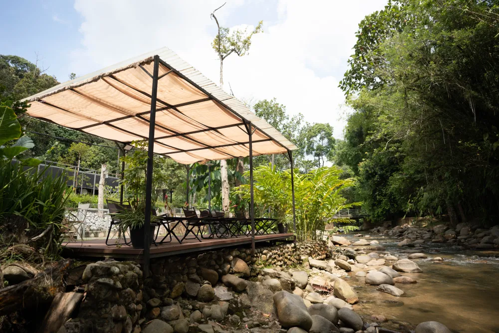 Riverside dining pavilion beside the stream